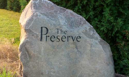 Instead of a traditional bronze sign you would see at most of our other properties, The Preserve, a unique green burial cemetery, greets visitors with a large, simple boulder with the cemetery name engraved on it.